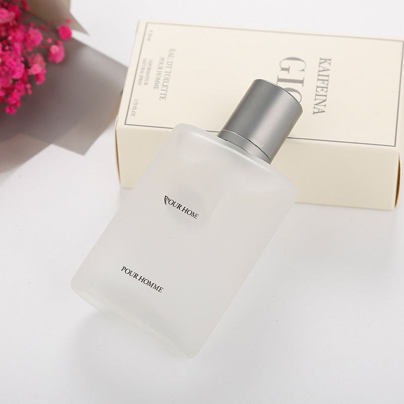 Perfume bottle labeled 'Pour Homme' with a box in the background